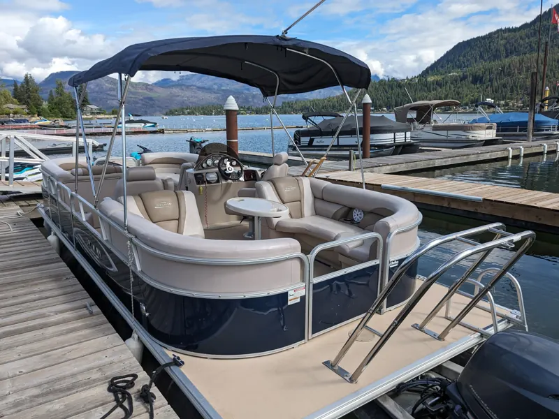 Pontoon boat tied up at the dock on Okanagan Lake